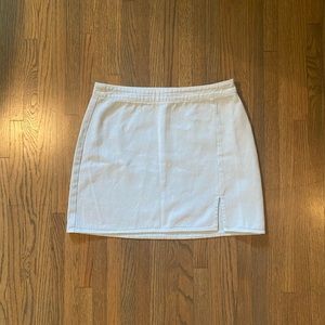 Light blue mini skirt with small slit over right leg
